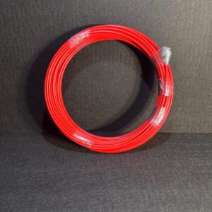 Alana 40 meter 7mm thick red flexible camera cable coiled on black background, plastic wrap securing the coil.