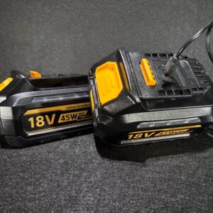 Alana displays two Dewalt Battery 4Ah 18V Twin Pack units in yellow and black, one charging, on a dark background.