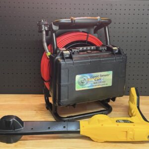 Black hard case with red coiled cable and Vivax Vloc 3 Locator from iSpec Compact Reel 23 kit on a wooden surface.