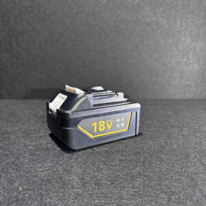 Alana shows a black Makita Battery 5Ah 18V on a dark textured surface with a plain background, emphasizing the battery.