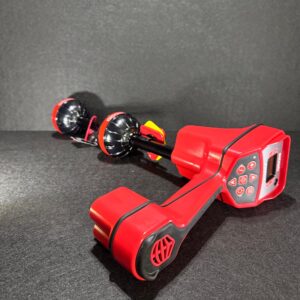Alana’s red Ridgid Scout device with black/yellow accents and two fan-like attachments on a dark surface.